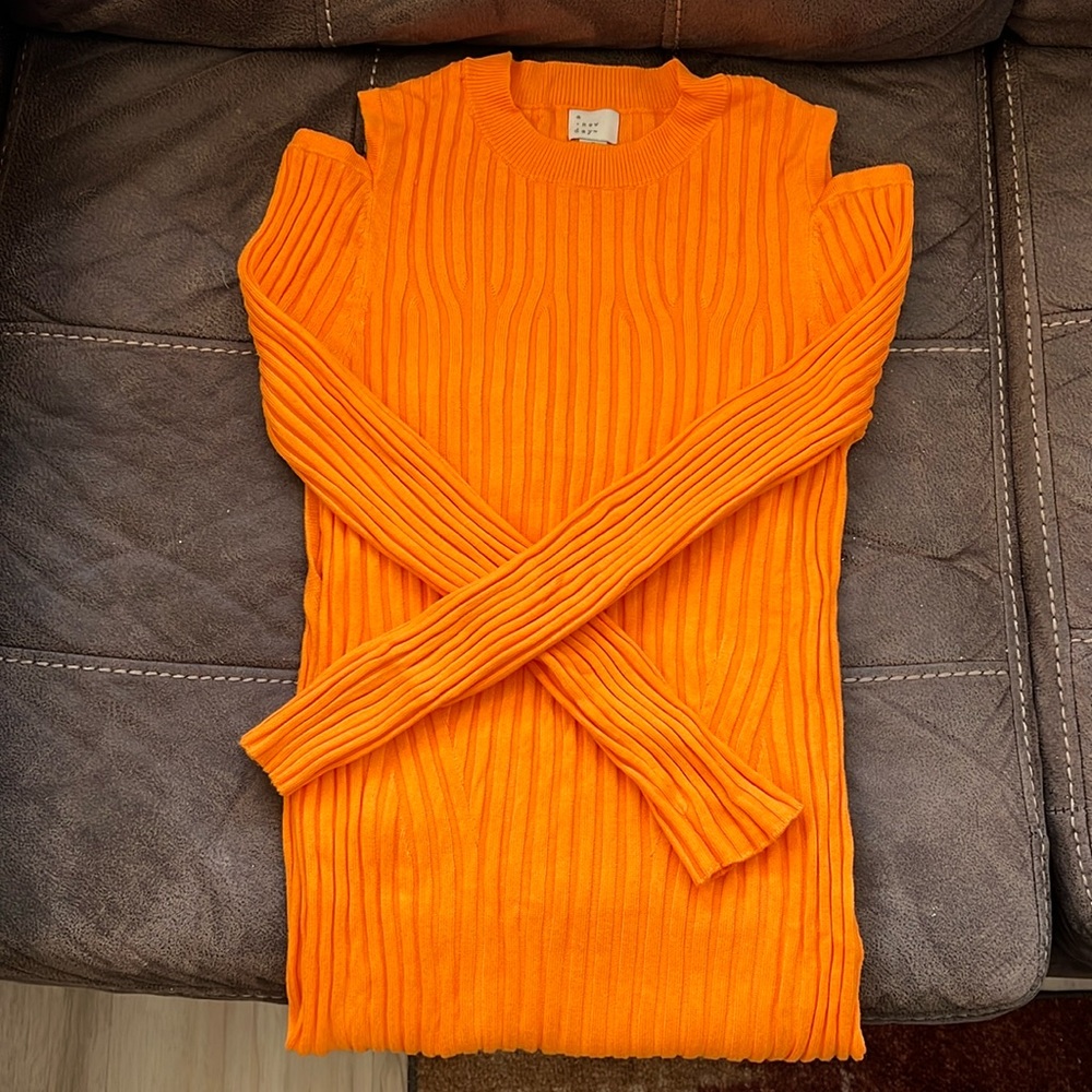 Bright orange long sleeve dress with cut on the shoulders